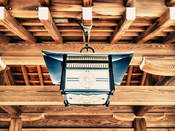 Low angle view of electric lamp hanging on ceiling