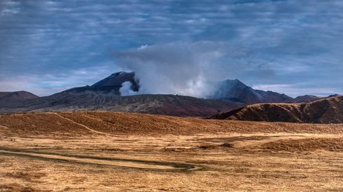 Scenic view of landscape and mountains against sky