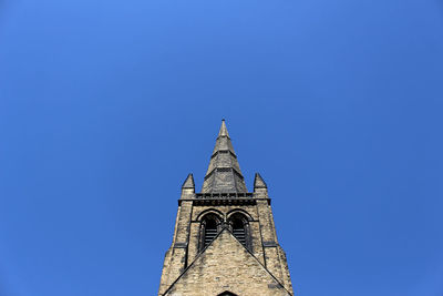 Low angle view of building against clear blue sky