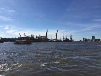 Commercial dock by sea against sky