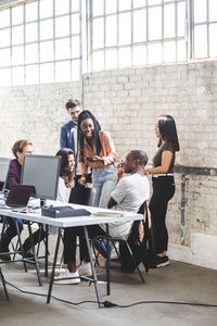 Team of happy computer hackers working together in creative office