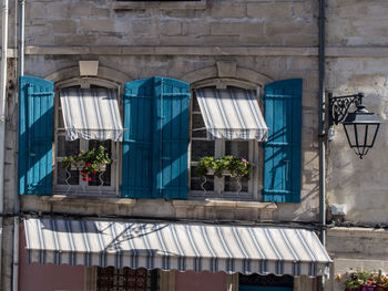 Low angle view of potted plants in balcony of building
