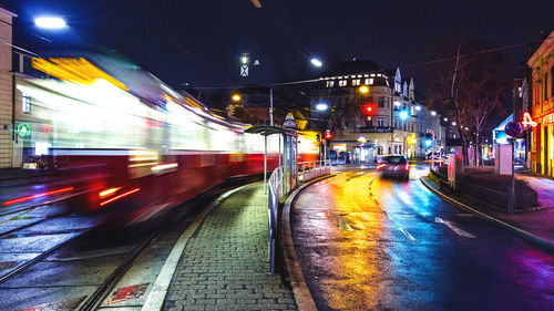 Railroad tracks in city at night