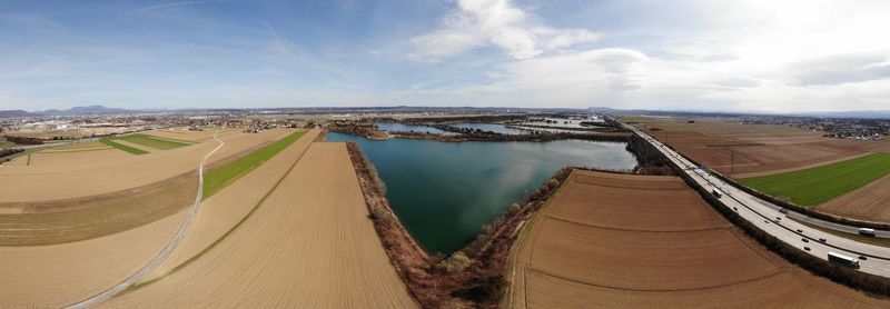 High angle view of river amidst land against sky