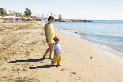 Full length of woman on beach against sea