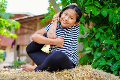Portrait of a smiling girl sitting outdoors