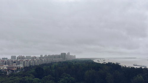 City skyline against cloudy sky