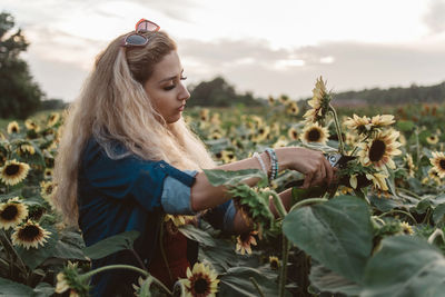 Young woman cutting plants