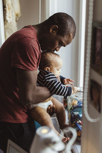 Father kissing on son's head at home