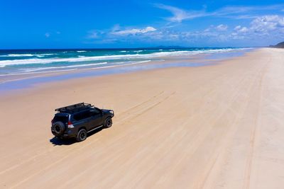 Lifeguard hut on beach against sky