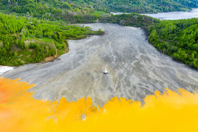 Aerial view of geamana church, romania flooded by copper mining waste water. acid yellow fluids 