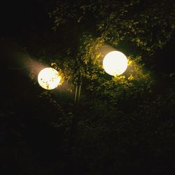 Low angle view of illuminated lights at night