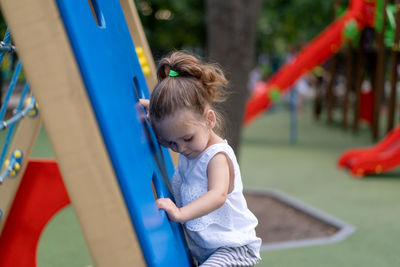 Side view of girl playing on playground