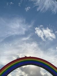 Low angle view of ferris wheel against blue sky