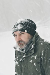 Portrait of young man skiing on snow