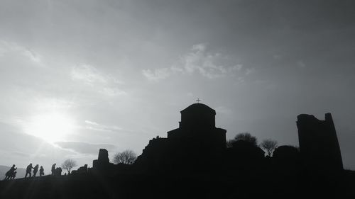 Low angle view of silhouette temple against sky