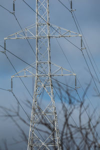 Low angle view of electricity pylon against sky