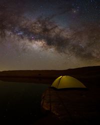 Scenic view of tent against sky at night