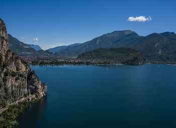 Scenic view of sea and mountains against blue sky