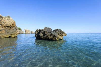 Rocks on the cliff of maro-cerro gordo, nerja, malaga, spain