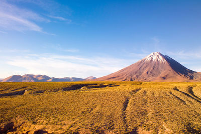 Scenic view of mountains against blue sky