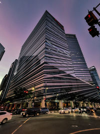 Traffic on road amidst buildings in city against sky