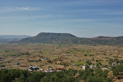 High angle view of houses and mountains against sky