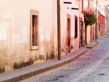 Empty street by old building in town