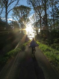 People walking on road at sunset