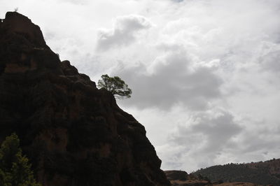 Low angle view of rock formation against sky