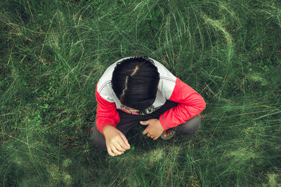 High angle view of man sitting on field