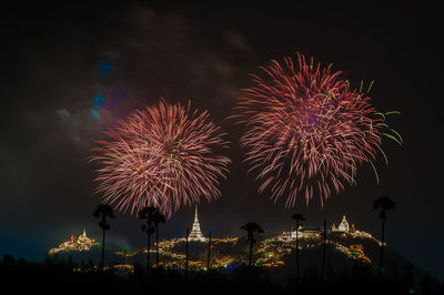 Low angle view of firework display in sky at night