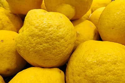 Close-up on a stack of citron - citrus medica - on a market stall.