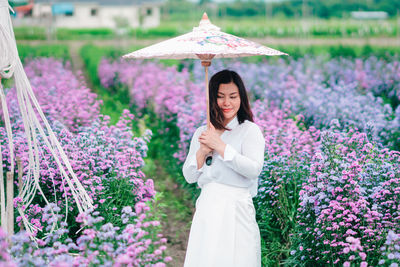 Woman standing on purple flowering plants