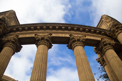 Low angle view of historical building against cloudy sky