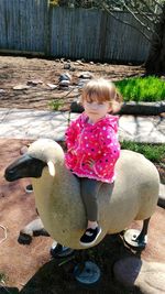 Rear view of cute girl on footpath