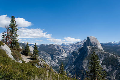 Scenic view of mountains against blue sky