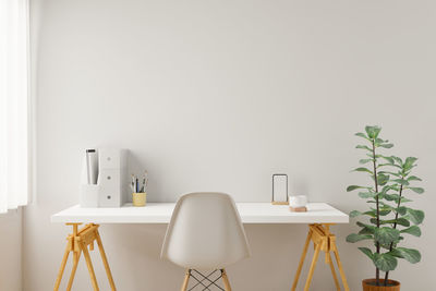 Chairs and table against white wall at home