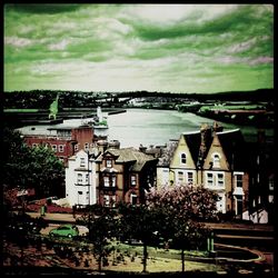 Residential buildings against cloudy sky