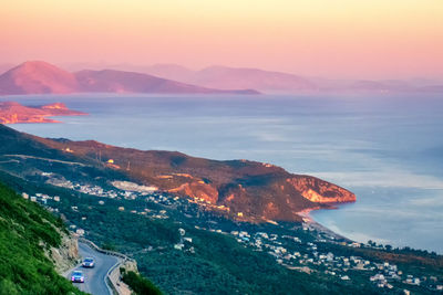 High angle view of townscape by sea against sky