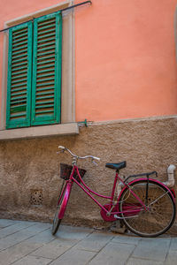 Bicycle against wall of building