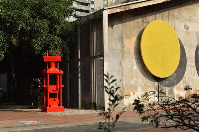 Information sign on road by building in city