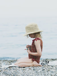 Girl playing with stones on beach