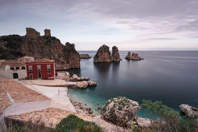 Panoramic view of sea and buildings against sky