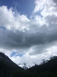 Low angle view of storm clouds over mountain