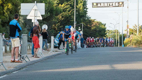 People riding bicycle on road in city