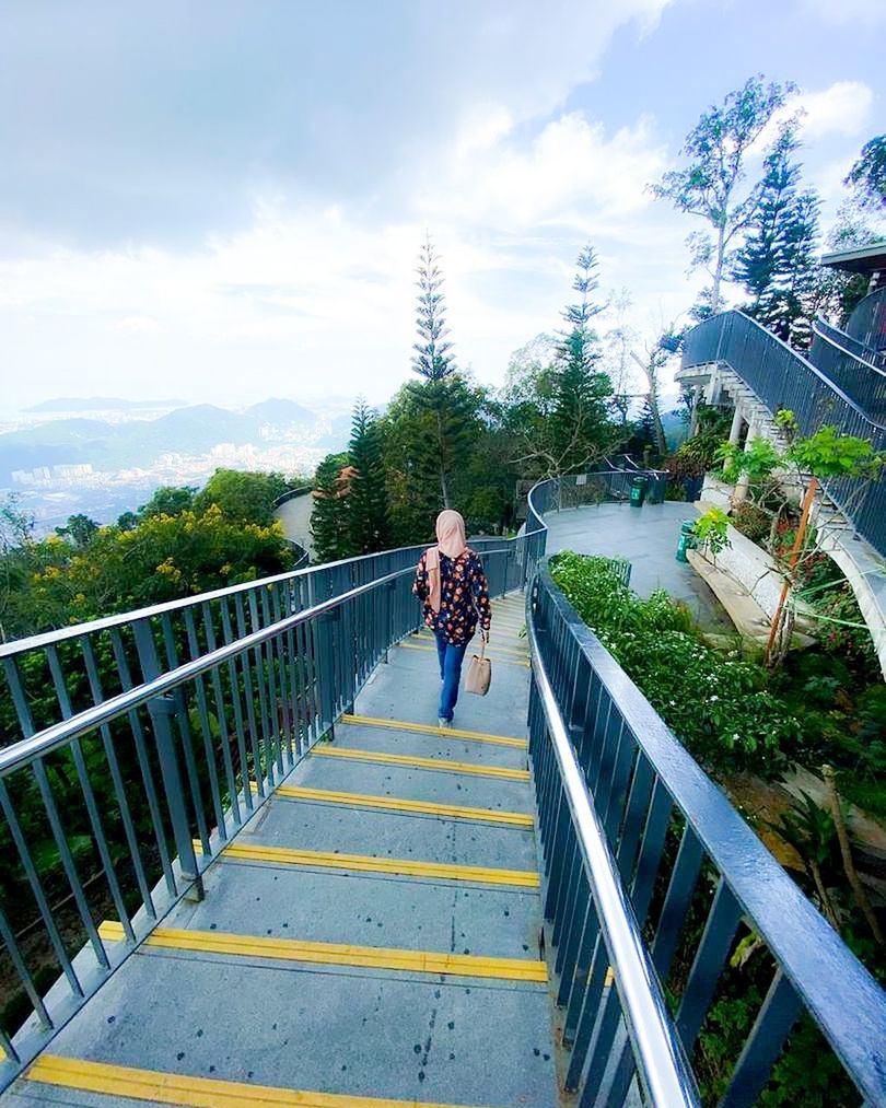 architecture, railing, sky, full length, adult, built structure, nature, cloud, lifestyles, women, plant, leisure activity, tree, bridge, one person, men, day, transportation, walking, walkway, city, vacation, outdoors, female, mountain, travel, the way forward, footpath, casual clothing, beauty in nature, staircase, footbridge, travel destinations, landscape, scenics - nature, motion, young adult, holiday, trip, activity, building exterior, tourism, road, rear view