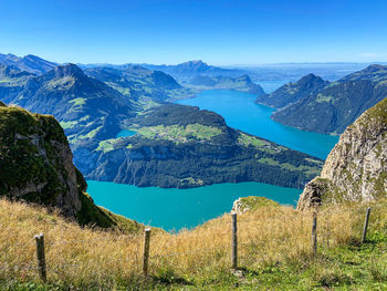 Scenic view of lake and mountains against blue sky