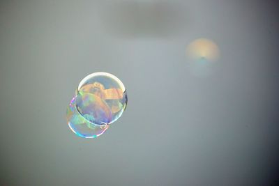 Low angle view of bubbles in mid-air