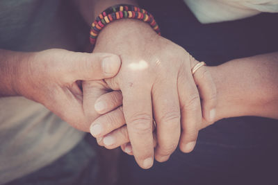 Close-up of hands touching foot